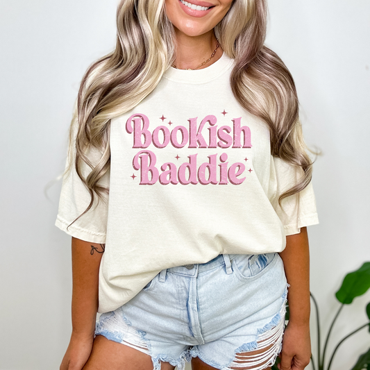 Introducing our "Bookish Baddie" Graphic Tee in bold and vibrant pink font – the trendy, fun, and uniquely expressive t-shirt that lets you flaunt your fierce bookish spirit!