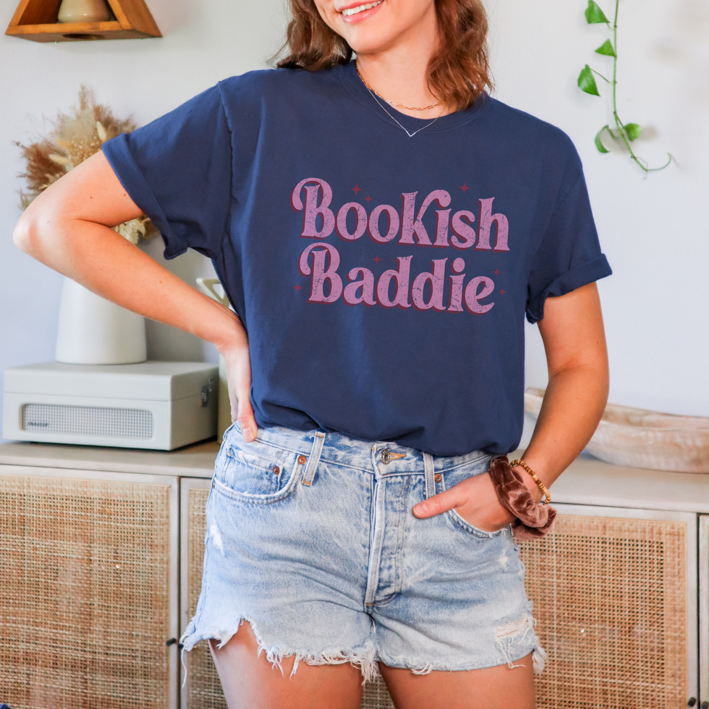 The striking pink font stands out in style, making a bold statement that declares your love for books with a fun and fashion-forward flair.