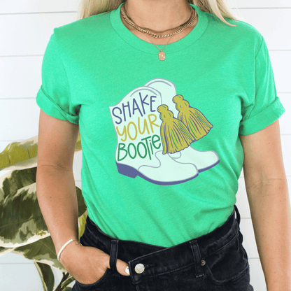 green mardi gras t-shirt for women that is great to wear for parades featuring an image of majorette boots saying shake your bootie